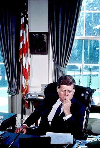 J.F.K looking intensely at his desk