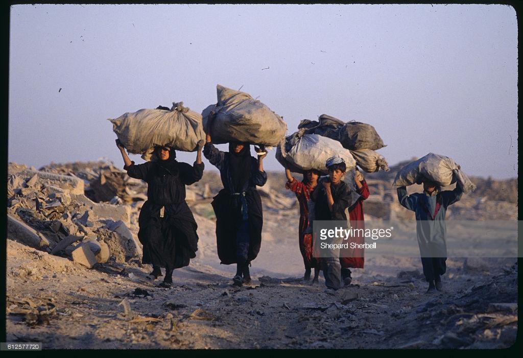 People carrying trash to dump.