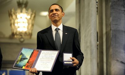 Barack Obama poses with his Nobel prize in Oslo in 2009
