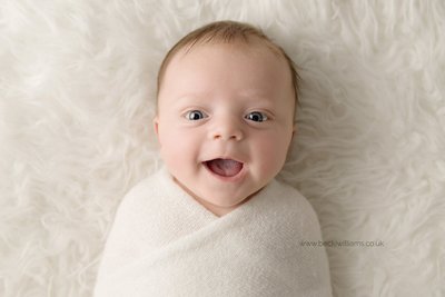 Baby begins to smile when others talk or smile at them