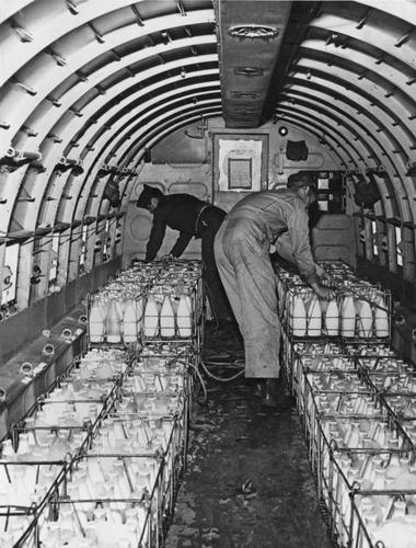 People Loading A Plane That Will Be Bringing Supplies To Berlin.