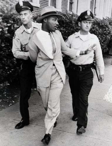 This shows Martin being arrested by 2 police officers