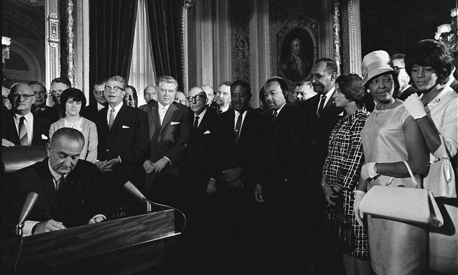 President Lyndon B. Johnson signing the Civil Rights Act of 1964.